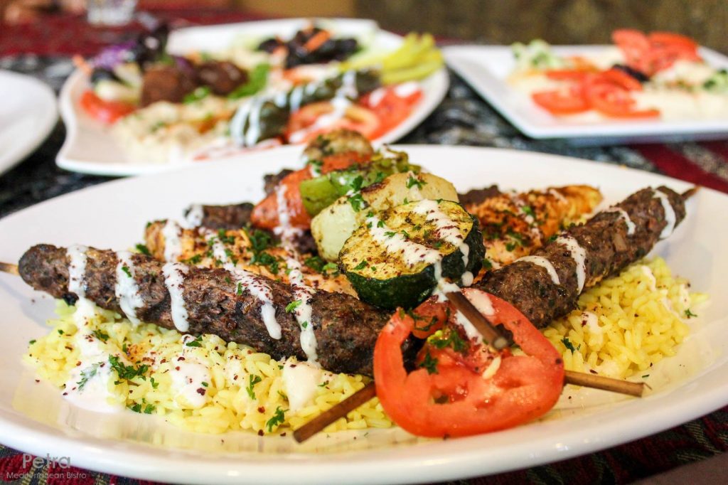 Combo Kabob dish, with Chicken, Kafta and Lamb kabobs, and a charbroiled veggie kabob. Served over rice and drizzled with Petra Bistro's housemade garlic sauce. Photo source.