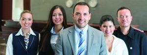 Portrait of a friendly hotel staff looking at the camera smiling - travel concepts